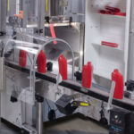 Compact Unscrambler shows with an open elevator for easy maintenance and container cleanout.