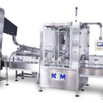 Rotary Plugger | Continuous motion rotary plugging machine that precisely aligns and places plugs or fitments into containers.