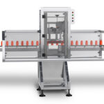 Belt transfer | Accepts containers from an infeed conveyor and transfers them to a belt assembly.